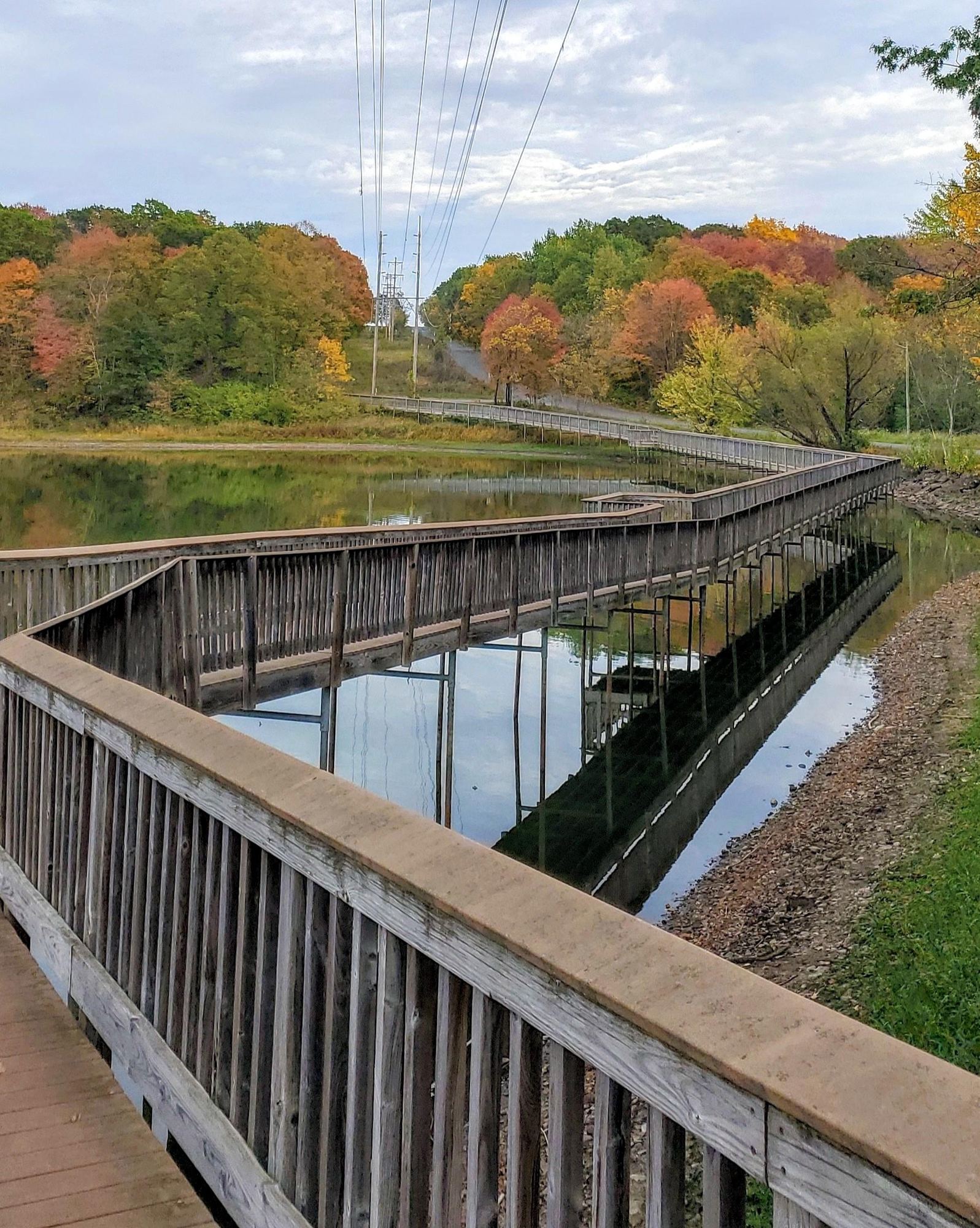 Boardwalk crossing Coon Lake in fall