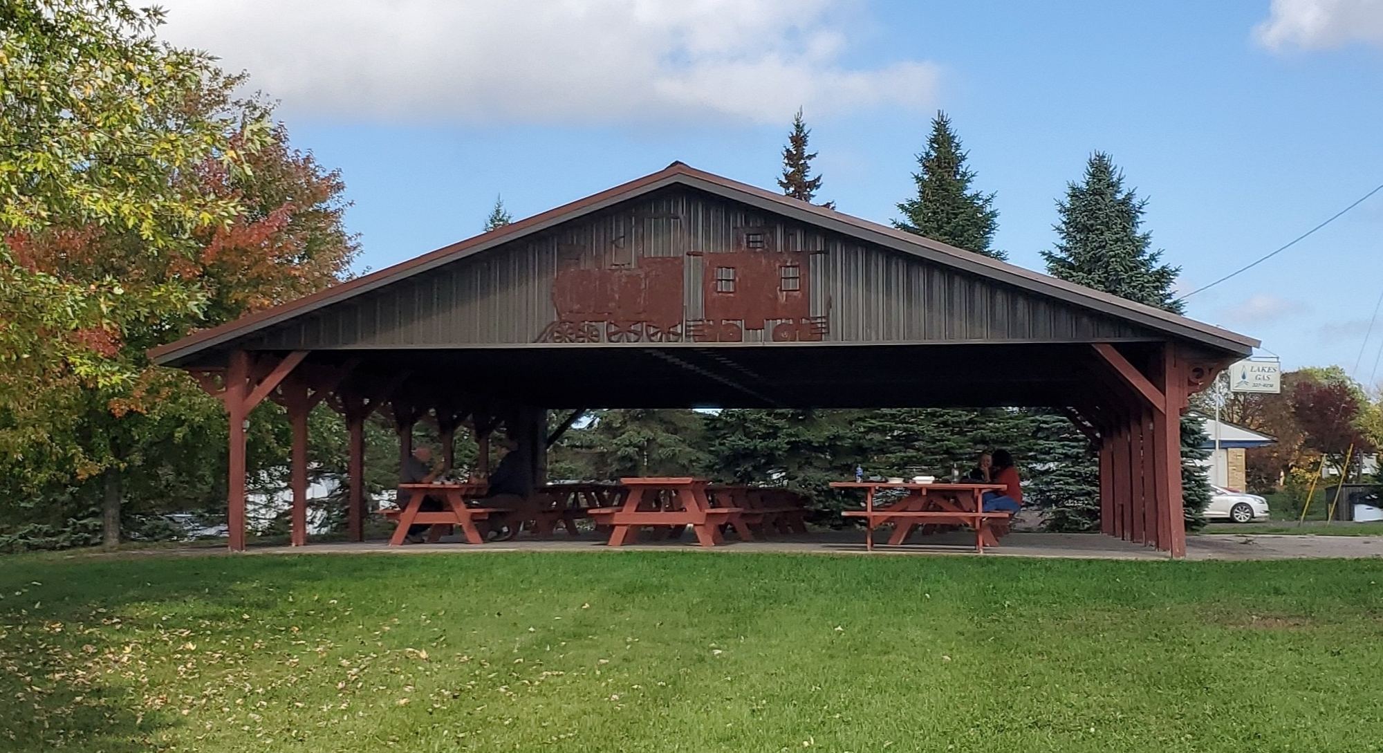 Open-sided picnic shelter in a village park